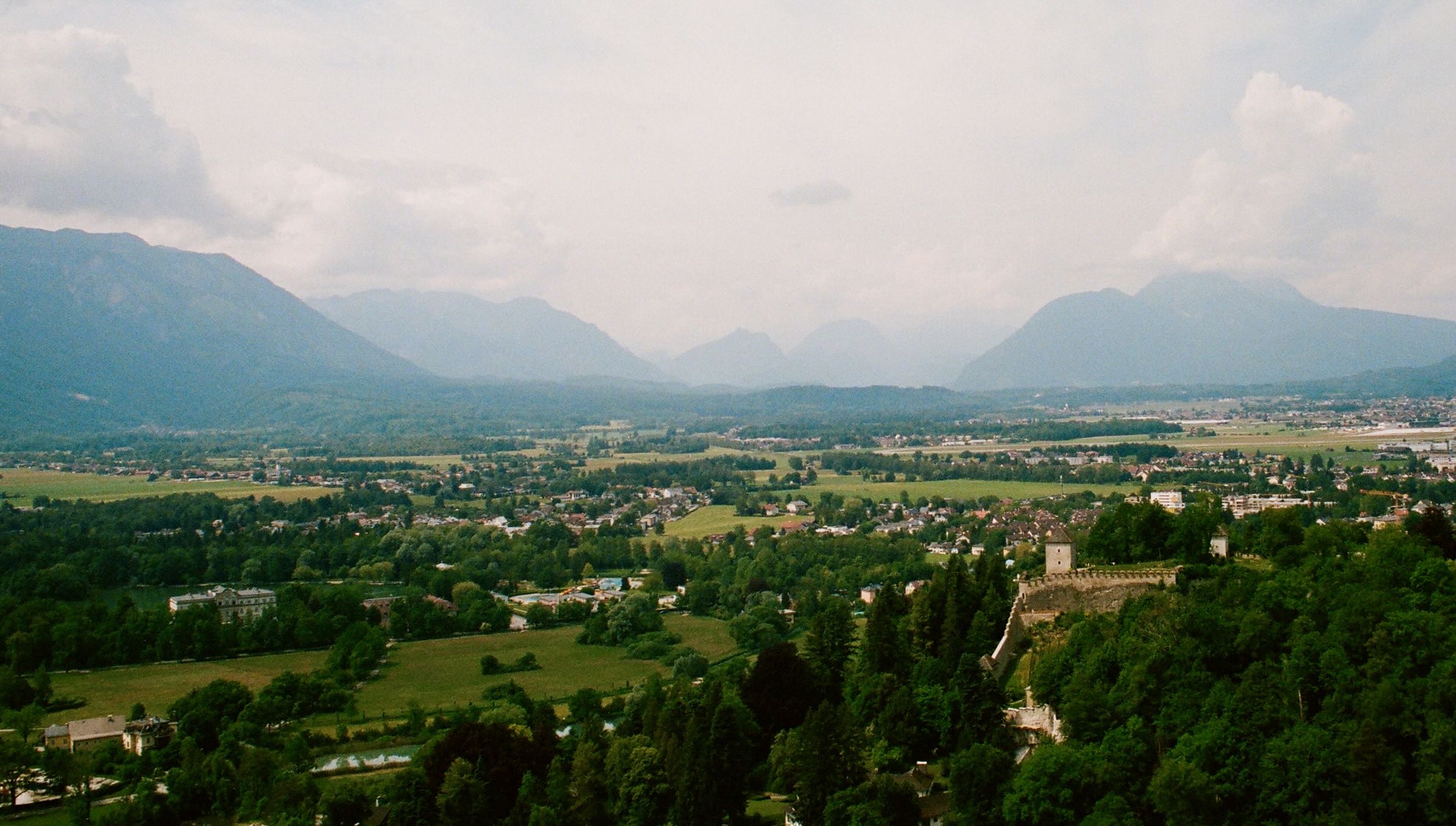 Green fields and distant mountains seen from fortress hohensalzburg in salzburg.