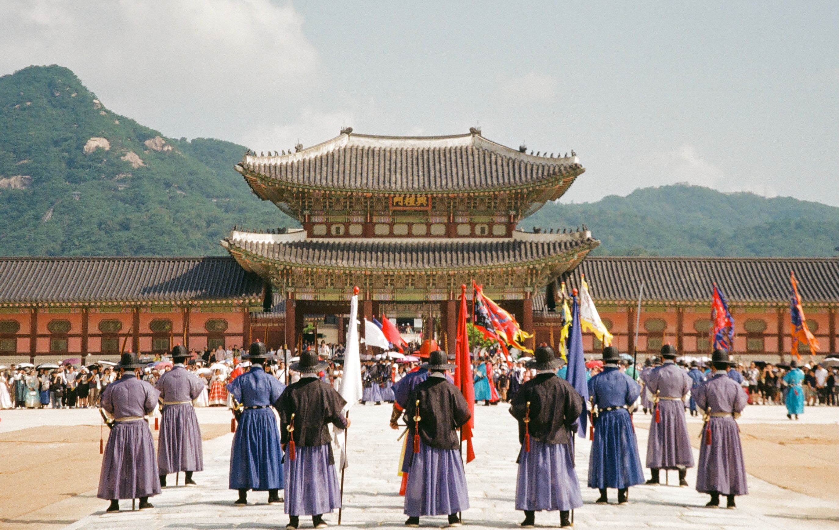 Guards in colorful traditional uniforms gathered outside heungnyemun gate in seoul.