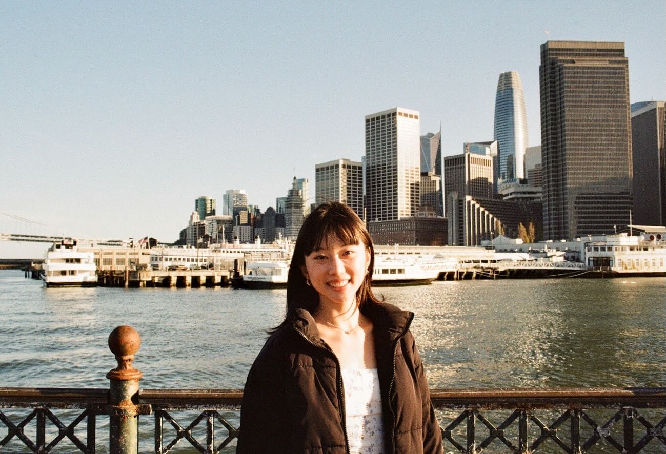 A portrait on the waterfront with the san francisco skyline behind the subject.