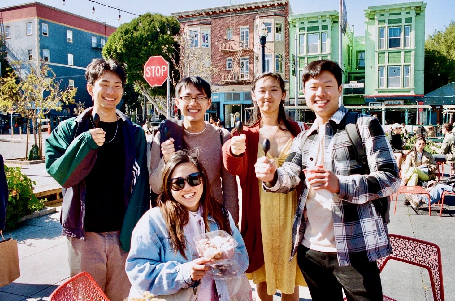 Friends gathered outside a café among colorful buildings in hayes valley.